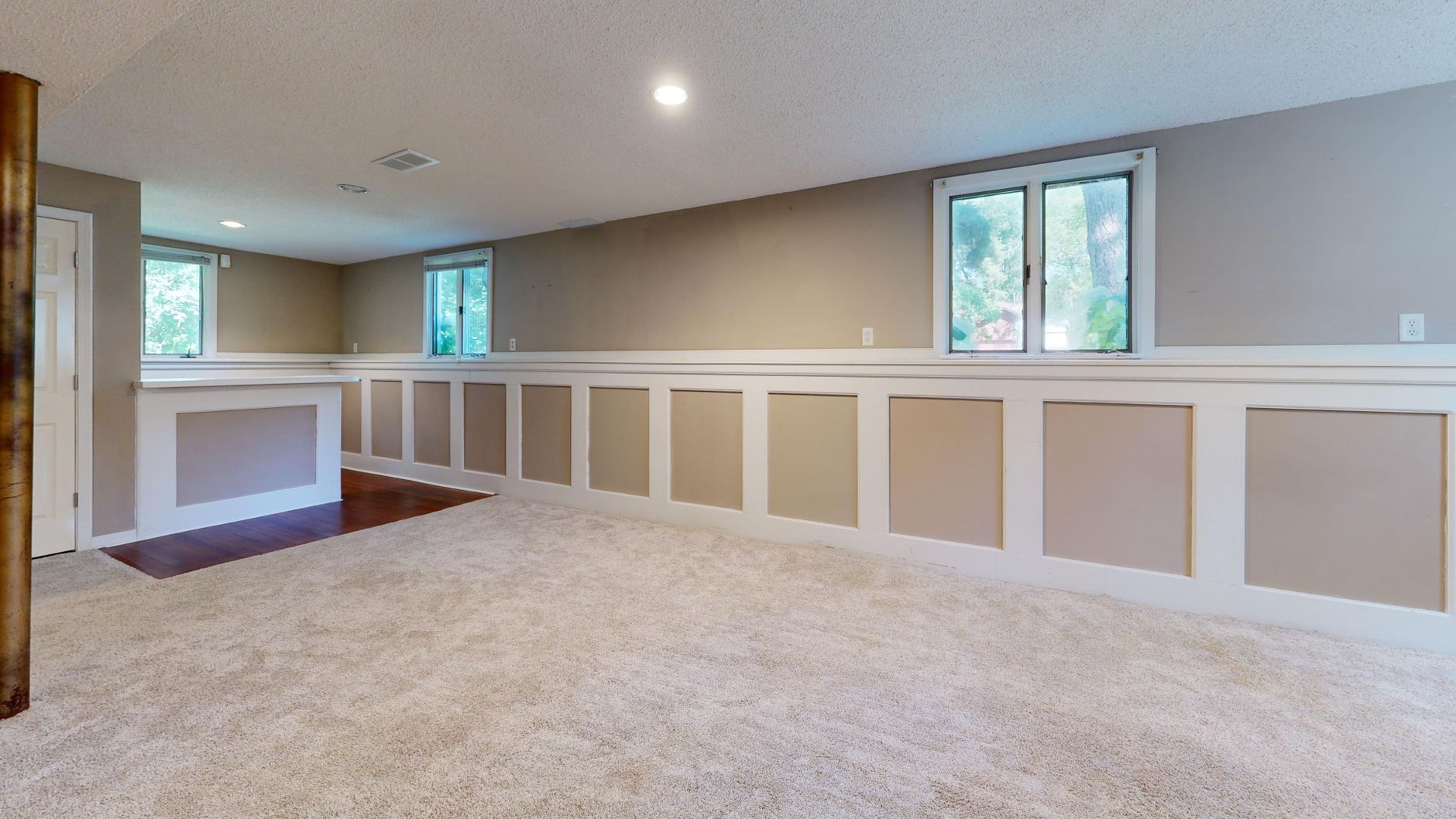 Bright finished basement interior with natural light
