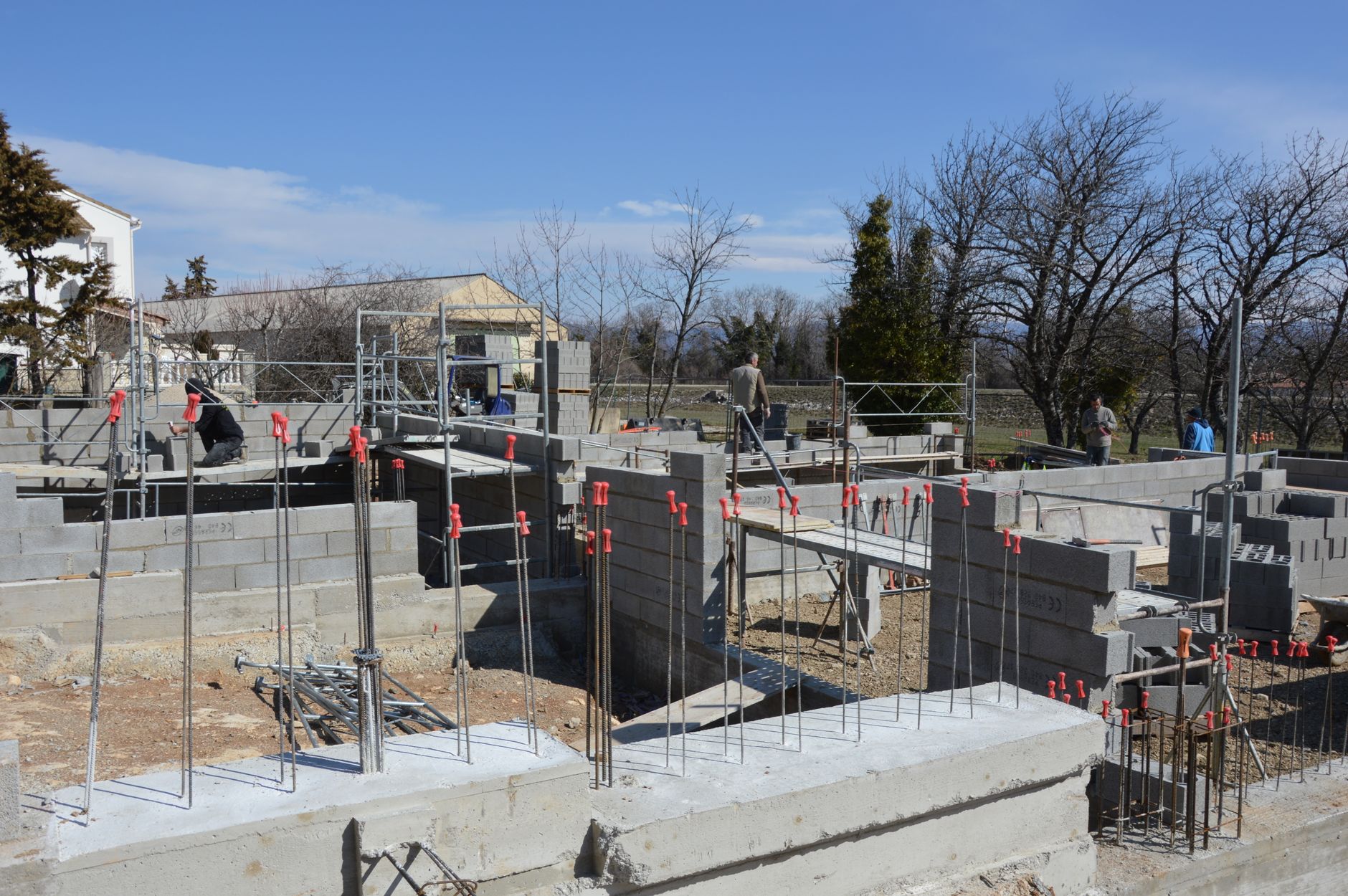 Block foundation walls going up on a poured concrete footing at a build site